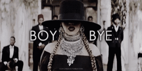 a woman wearing a hat and a necklace is standing in front of a group of men with the words boy bye above her