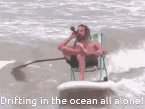 a man sitting in a chair on a surfboard in the ocean with the words drifting in the ocean all alone