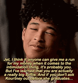 a man with curly hair is smiling with his eyes closed and a quote .