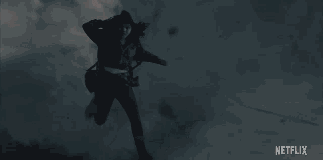 a woman in a red jacket is running in the dark with a netflix logo in the background