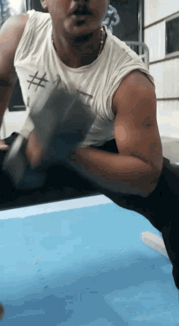 a man is lifting a dumbbell in a gym