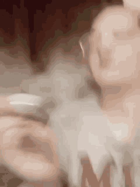 a close up of a person smoking a cigarette with smoke coming out of it .