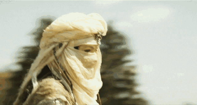 a person wearing a white scarf around their face and head