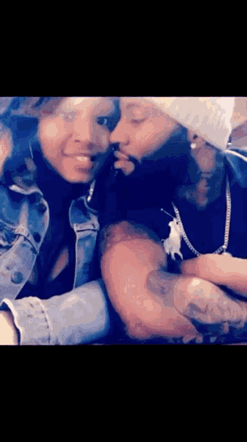 a man and a woman are hugging each other and kissing .