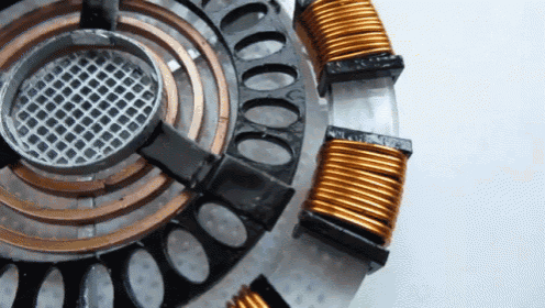 a close up of a circular object with copper wires