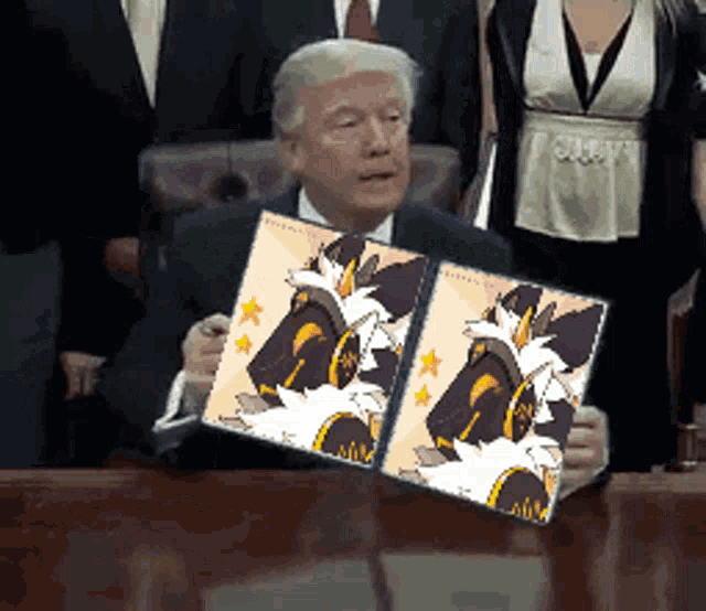 a man in a suit and tie is holding a picture of a cartoon character