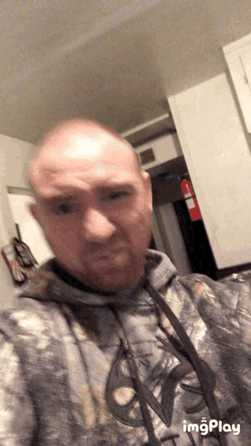 a man taking a selfie with a hoodie that says imgplay