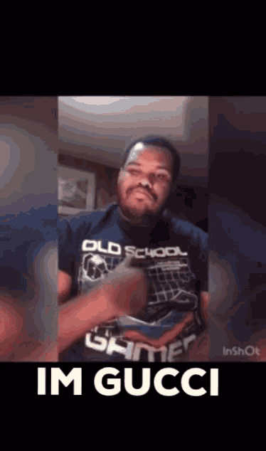 a man wearing a shirt that says old school gamer on it