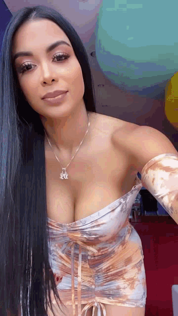 a woman in a strapless dress is taking a selfie .