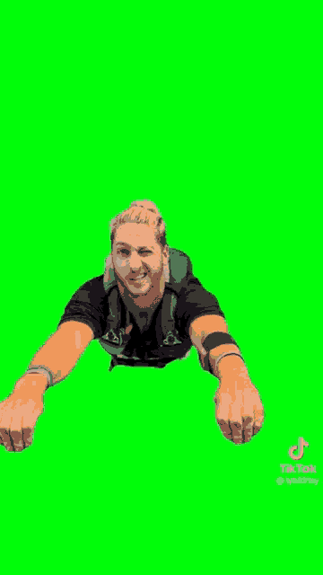 a man is flying through the air on a green screen