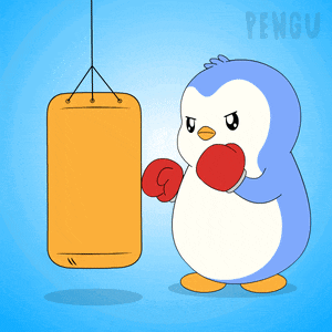 a penguin wearing red boxing gloves stands next to a punching bag
