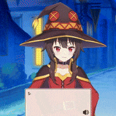 a girl wearing a witch hat is holding a laptop computer