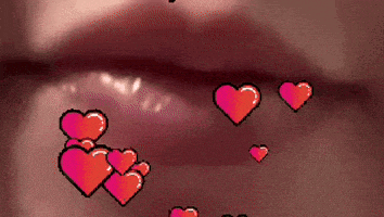 a close up of a woman 's lips with hearts coming out of it .