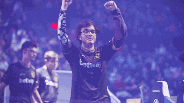 a man with his arms in the air with the word m21 in the background
