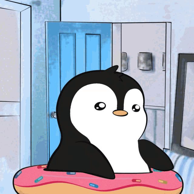 a penguin is sitting on a pink donut in front of a blue door