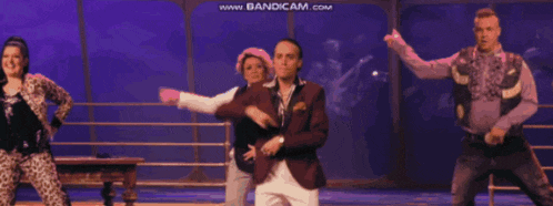 a group of people dancing on a stage with the words www.bandicam.com visible