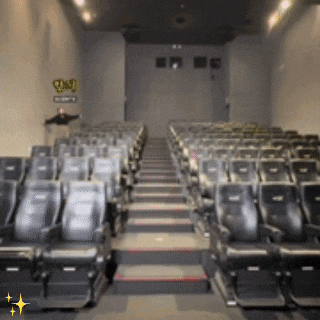 a row of empty seats in an auditorium with a sign on the wall that says ' q & o '