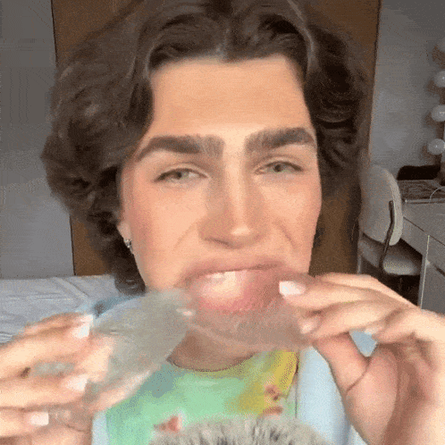 a close up of a person holding a brush in their mouth