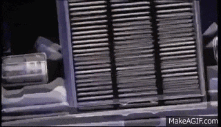 a close up of a grille on a car with a can of soda on it .