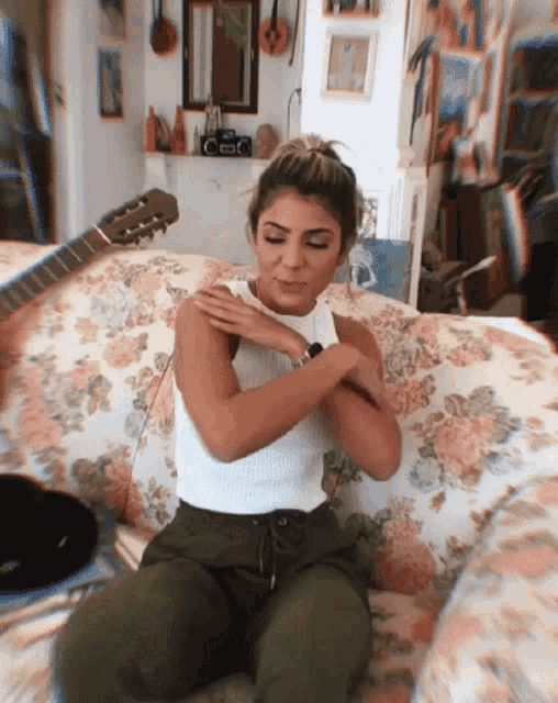 a woman is sitting on a couch with her arms crossed