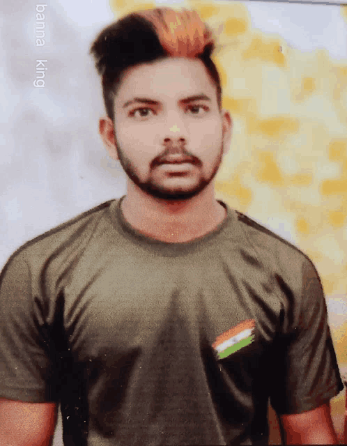 a man with a beard is wearing a green shirt with an indian flag on the front