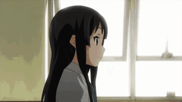 a girl with long black hair looks out a window