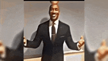 a man in a suit and tie is standing with his arms outstretched