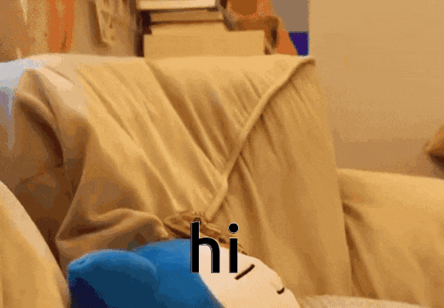 a couch with a blanket on it and the word hi written on it