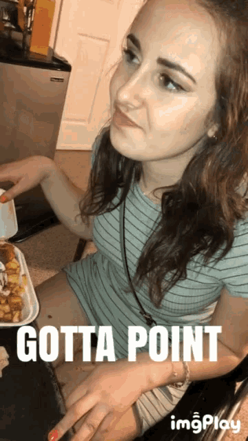 a woman in a striped shirt is sitting at a table with a tray of food and the words gotta point below her
