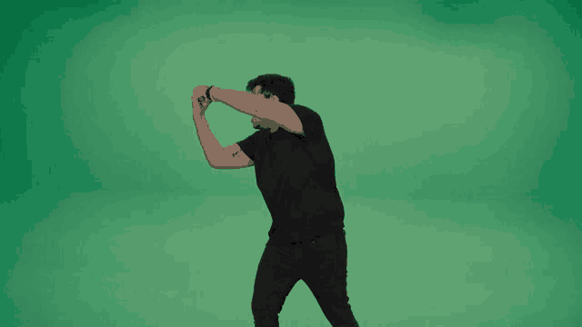 a man with a tattoo on his arm is dancing