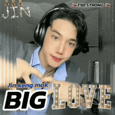 a young man wearing headphones and making a heart with his hand with the word big love behind him