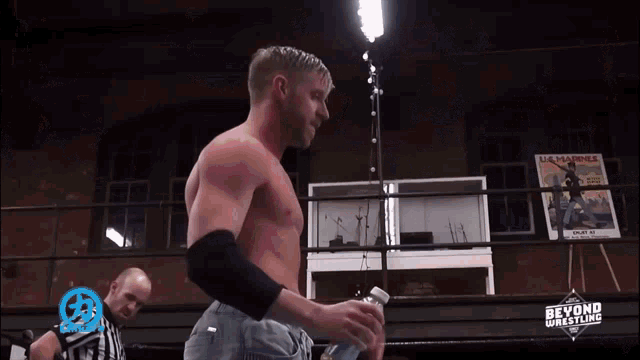 a man in a boxing ring with a sign that says beyond wrestling