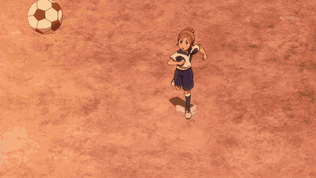 two soccer players on a field with a soccer ball in the foreground and tv tokyo in the corner
