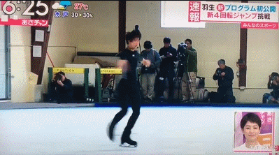 a man is skating on a ice rink with a caution sign in front of him
