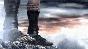 a person standing on a rock wearing sandals and socks