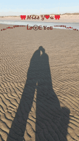 a shadow of a couple kissing on a beach with the words miss you and love you