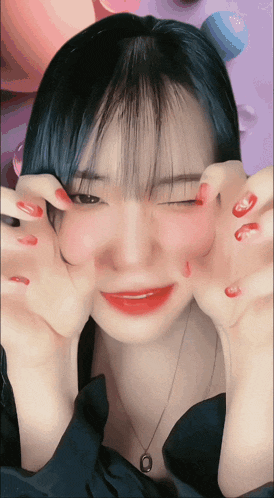 a woman with red nails is making a funny face with her hands