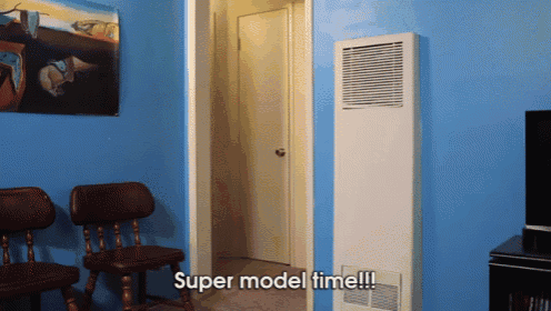 a room with blue walls and the words super model time written on the wall