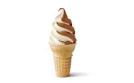 a close up of an ice cream cone with a swirl of ice cream on a white background .