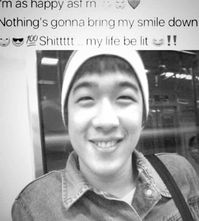 a black and white photo of a young man with the caption i 'm as happy as i 'm