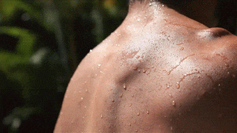 a man 's back is wet with water drops on it