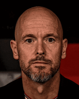 a man with a beard and bald head looks at the camera