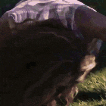 a woman 's hair is blowing in the wind in a blurry photo