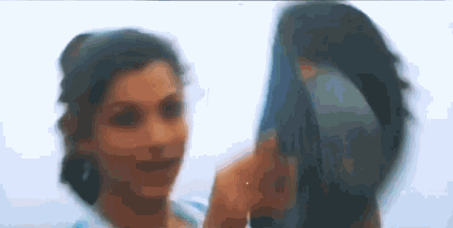 two women are standing next to each other and looking at each other .