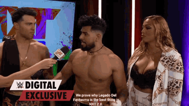 two men and a woman are standing in front of a sign that says ' digital exclusive '