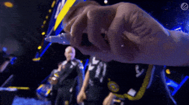 a blurry picture of a person holding a bottle with the letter l on it