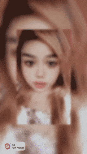 a blurred image of a woman 's face with the words ez gif maker on the bottom left