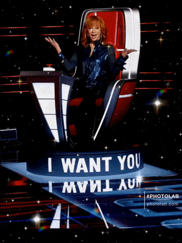 a woman sits in a chair with a sign that says i want you