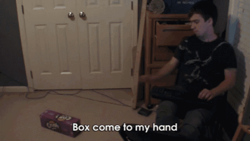 a man sits in a chair with a box of fritos in front of him that says box come to my hand