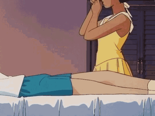a girl in a yellow dress is laying on a bed with her legs crossed